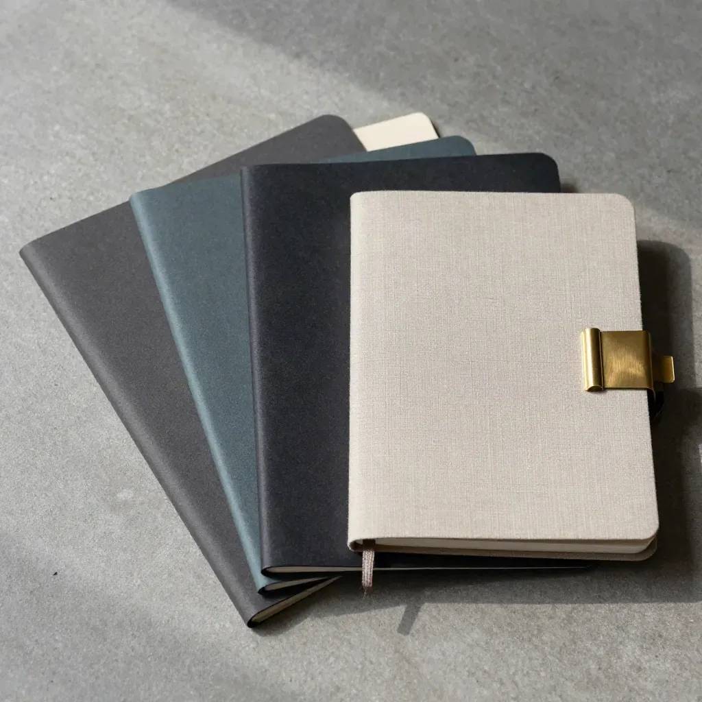 Overhead folders, notebook, and brass clip on concrete, arranged for choosing a learning path.